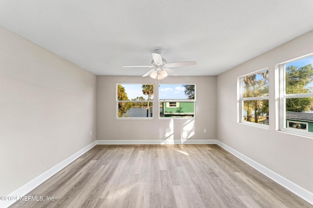 spare room with ceiling fan and light hardwood / wood-style floors