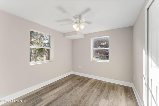 spare room with hardwood / wood-style floors and ceiling fan