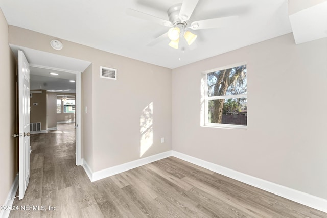 unfurnished room with ceiling fan and wood-type flooring