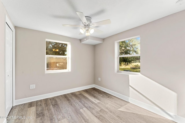 spare room with ceiling fan and light hardwood / wood-style floors