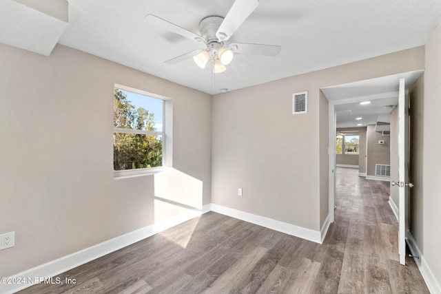 unfurnished room with ceiling fan and hardwood / wood-style flooring