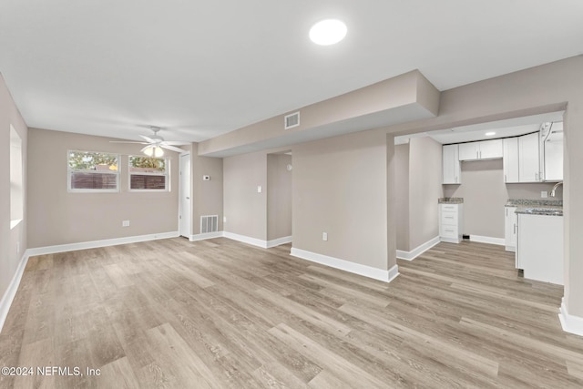 unfurnished living room with ceiling fan and light hardwood / wood-style floors