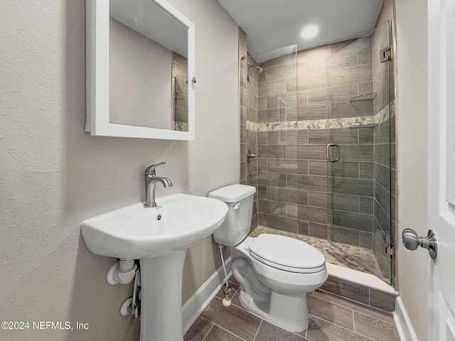 bathroom featuring toilet and walk in shower