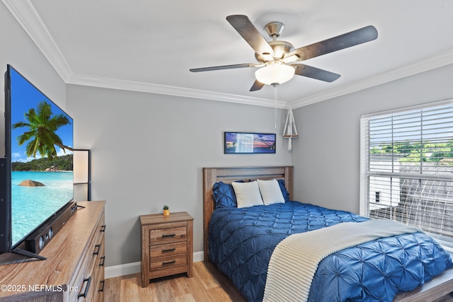 bedroom with light wood-type flooring, ceiling fan, and crown molding