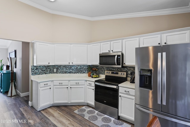 kitchen with tasteful backsplash, white cabinetry, ornamental molding, and appliances with stainless steel finishes