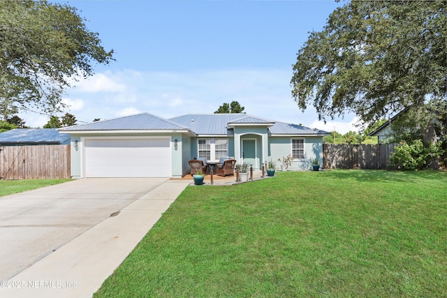 single story home with a garage, a front lawn, and a patio area