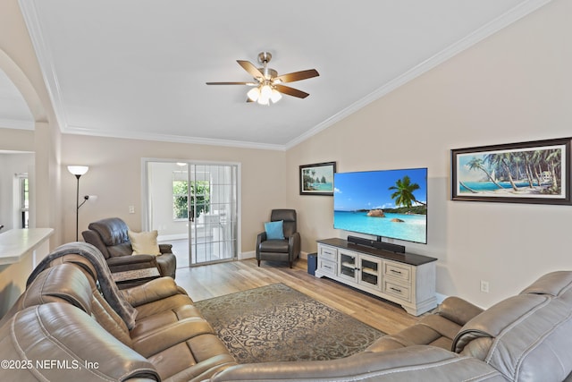 living room with ceiling fan, crown molding, light hardwood / wood-style floors, and vaulted ceiling