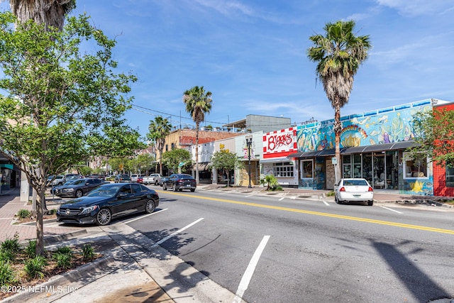 view of street with sidewalks, street lighting, and curbs