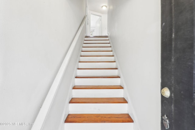 stairway featuring baseboards