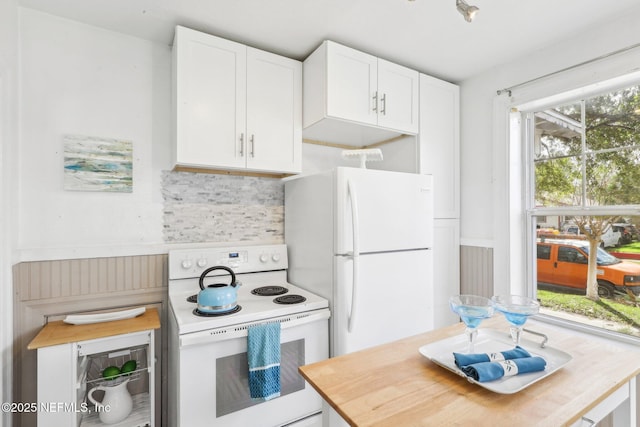 kitchen with tasteful backsplash, white appliances, and white cabinetry