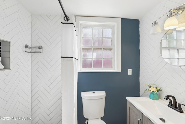 bathroom with toilet, a shower, backsplash, and vanity