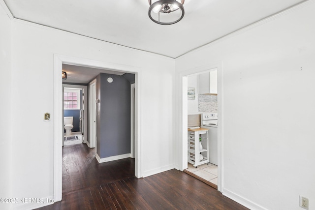 interior space with washer / clothes dryer, baseboards, and hardwood / wood-style flooring