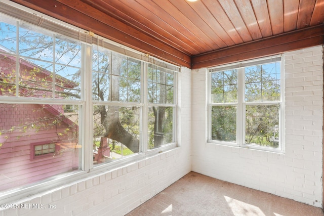 unfurnished sunroom with wood ceiling