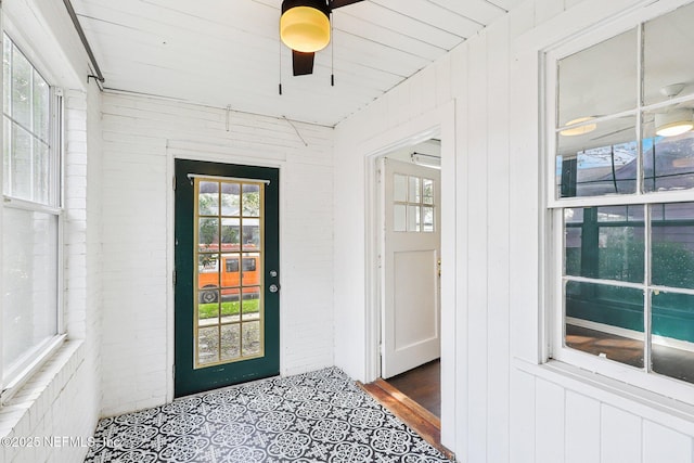 view of exterior entry featuring a ceiling fan