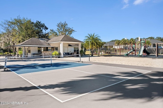 view of sport court with a playground