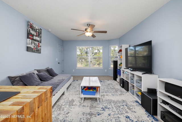 carpeted living room with ceiling fan