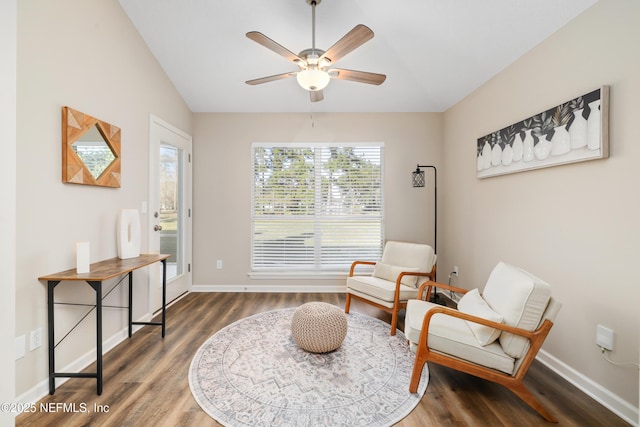 living area with dark hardwood / wood-style flooring, vaulted ceiling, and ceiling fan