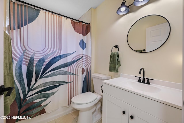 bathroom featuring tile patterned floors, vanity, and toilet