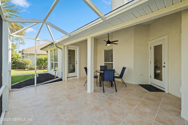 unfurnished sunroom featuring ceiling fan