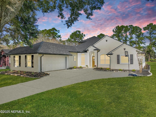 view of front of house featuring a yard and a garage