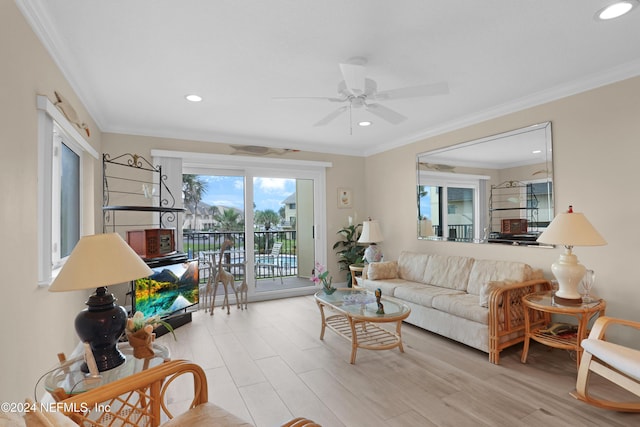 living room featuring light wood-type flooring, ceiling fan, and ornamental molding