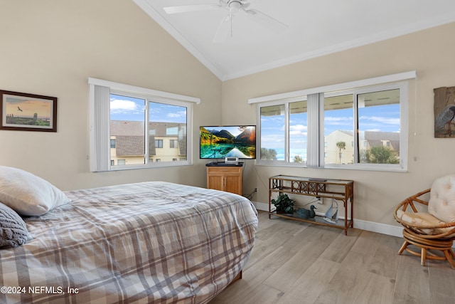 bedroom with light wood-type flooring, crown molding, ceiling fan, and lofted ceiling