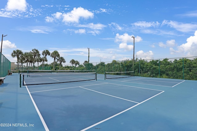 view of tennis court featuring basketball hoop