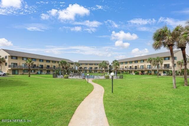 view of home's community featuring a lawn