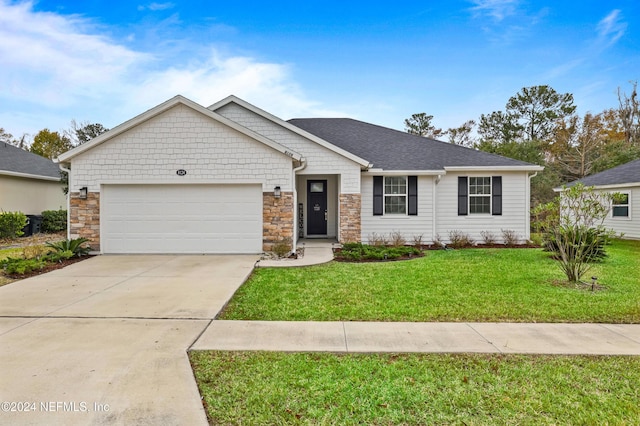 ranch-style home with a garage and a front lawn