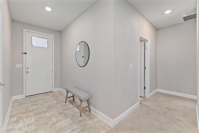 entrance foyer featuring light colored carpet