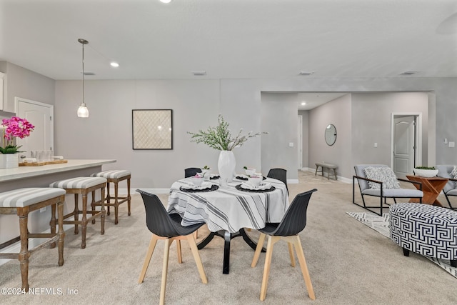 dining area featuring light colored carpet