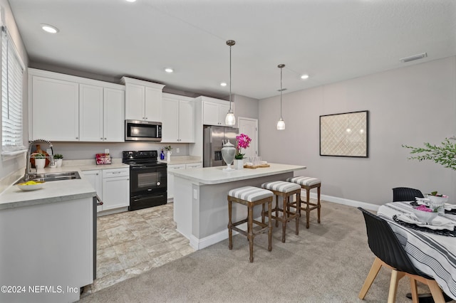 kitchen with white cabinetry, sink, hanging light fixtures, a kitchen island, and appliances with stainless steel finishes