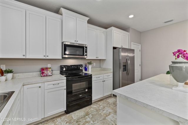 kitchen with sink, white cabinetry, and stainless steel appliances