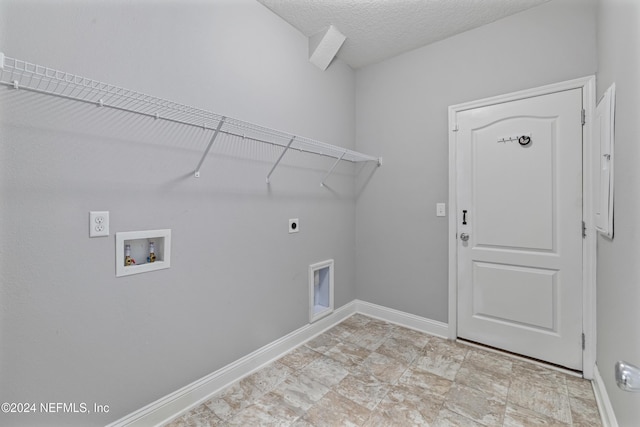 washroom with washer hookup, a textured ceiling, and electric dryer hookup