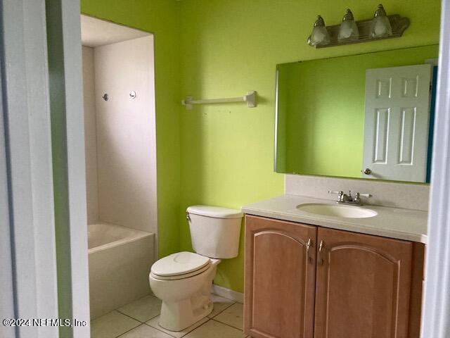 full bathroom with tile patterned floors, vanity,  shower combination, and toilet