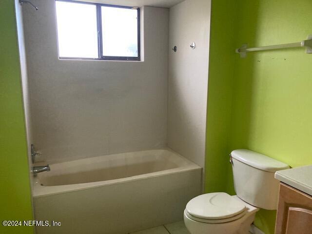 full bathroom with tile patterned floors, vanity, toilet, and shower / washtub combination