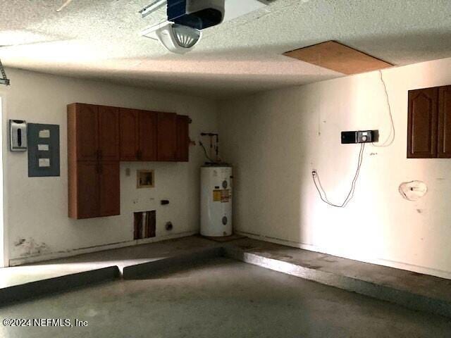 garage with gas water heater, a garage door opener, and electric panel