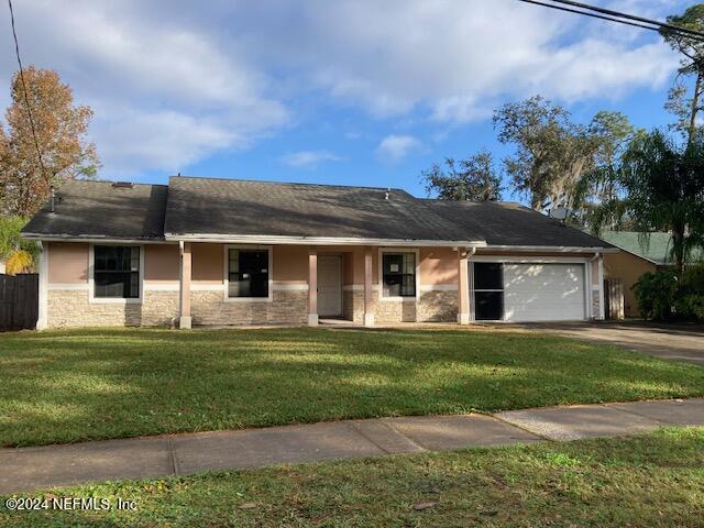 single story home with a front lawn and a garage