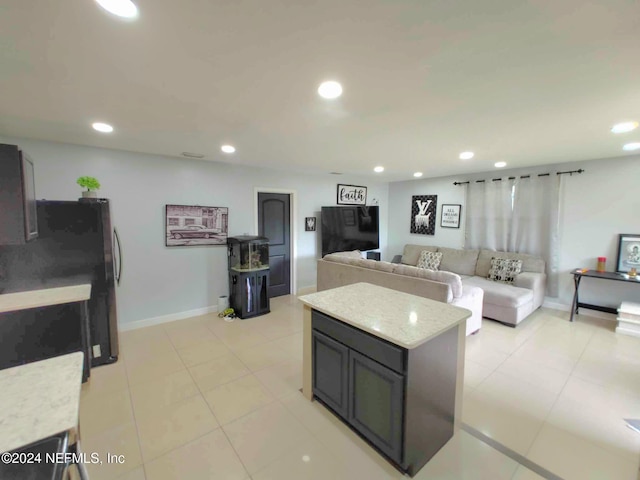 kitchen featuring freestanding refrigerator, open floor plan, and recessed lighting