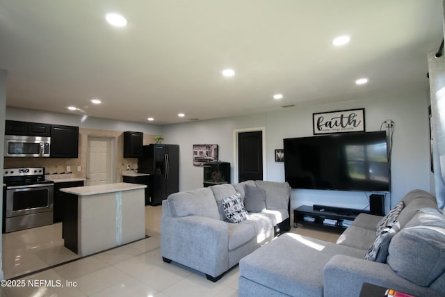 living room featuring light tile patterned flooring and recessed lighting