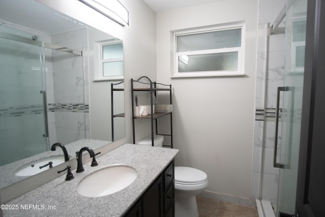 full bathroom with baseboards, a shower stall, toilet, and vanity