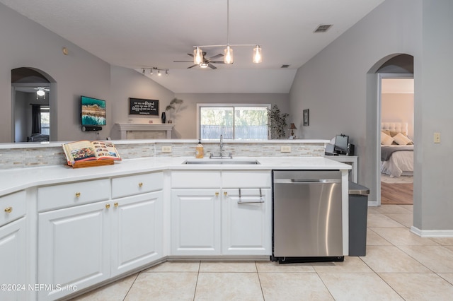 kitchen with lofted ceiling, sink, stainless steel dishwasher, ceiling fan, and white cabinetry