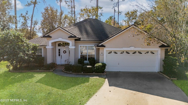 view of front of property with a front yard and a garage