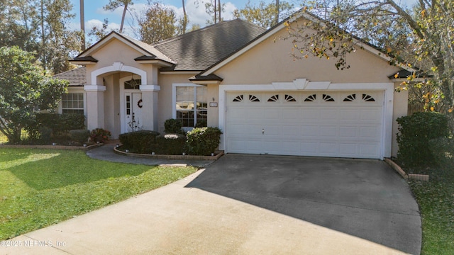 single story home with a garage and a front lawn