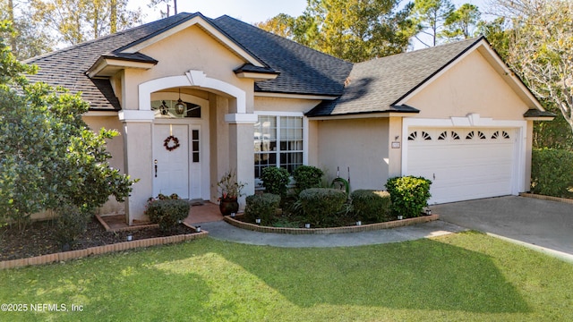 view of front of property with a front yard and a garage