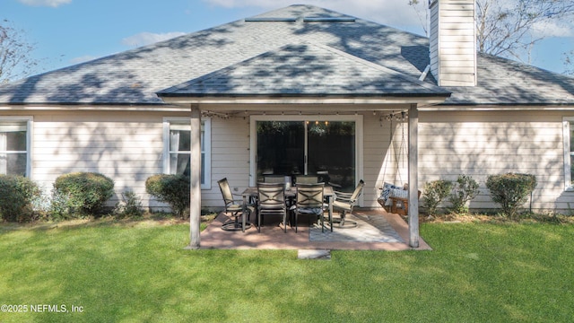 back of property featuring a patio area and a yard