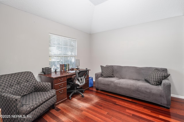 office area featuring dark wood-type flooring and vaulted ceiling