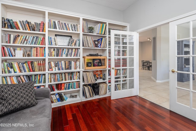 sitting room with french doors and hardwood / wood-style flooring