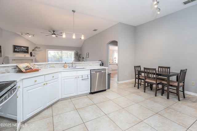 kitchen with white cabinetry, sink, ceiling fan, stainless steel appliances, and vaulted ceiling