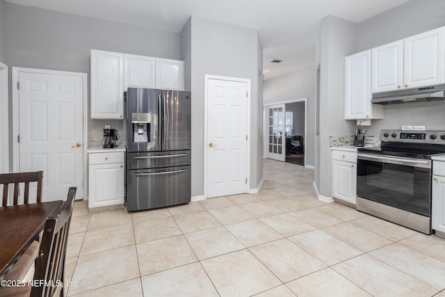 kitchen featuring white cabinets, stainless steel appliances, and light tile patterned floors